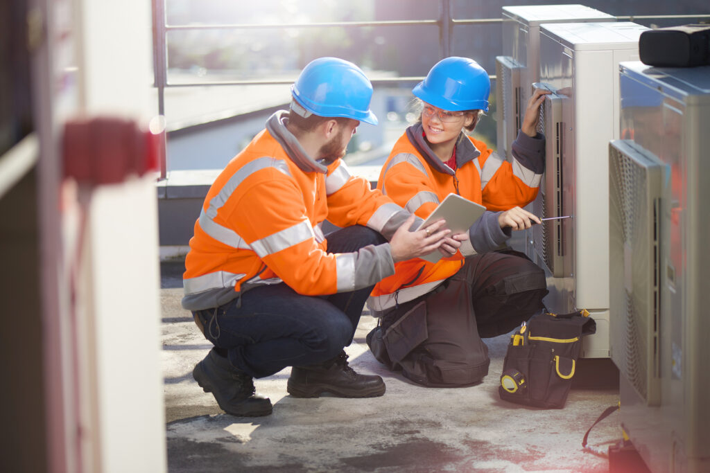 header image hvac technicians working on outdoor a/c unit