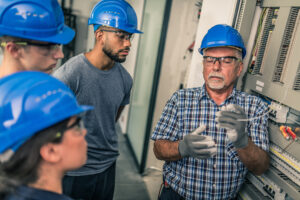 teacher showing class how to work with electrical wiring