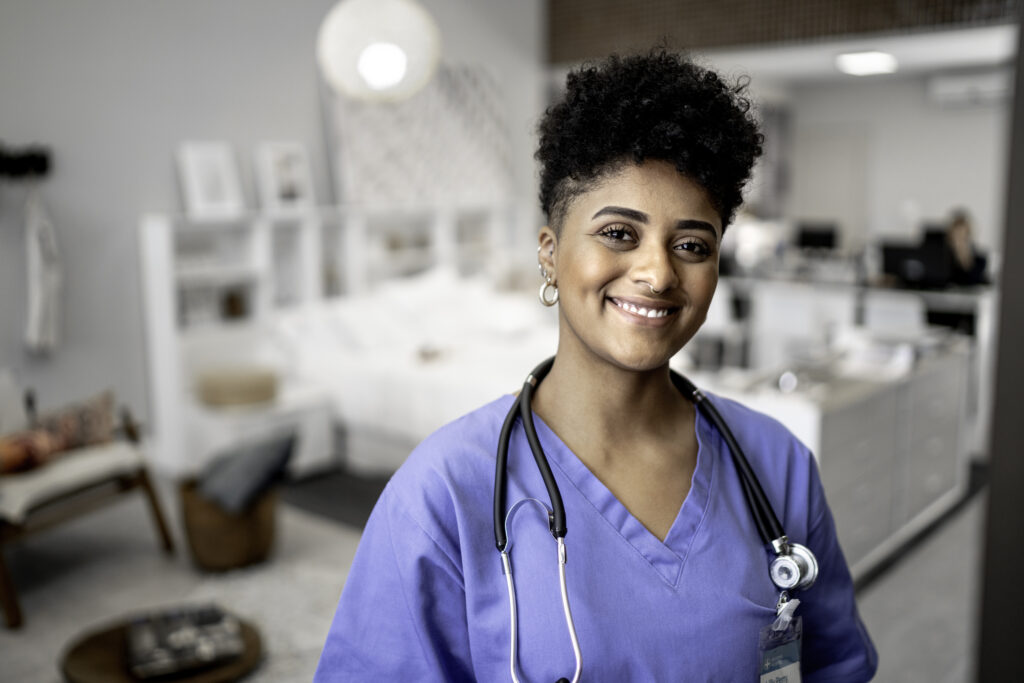 nurse smiling at camera in hospital room