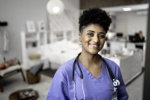 nurse smiling at camera in hospital room